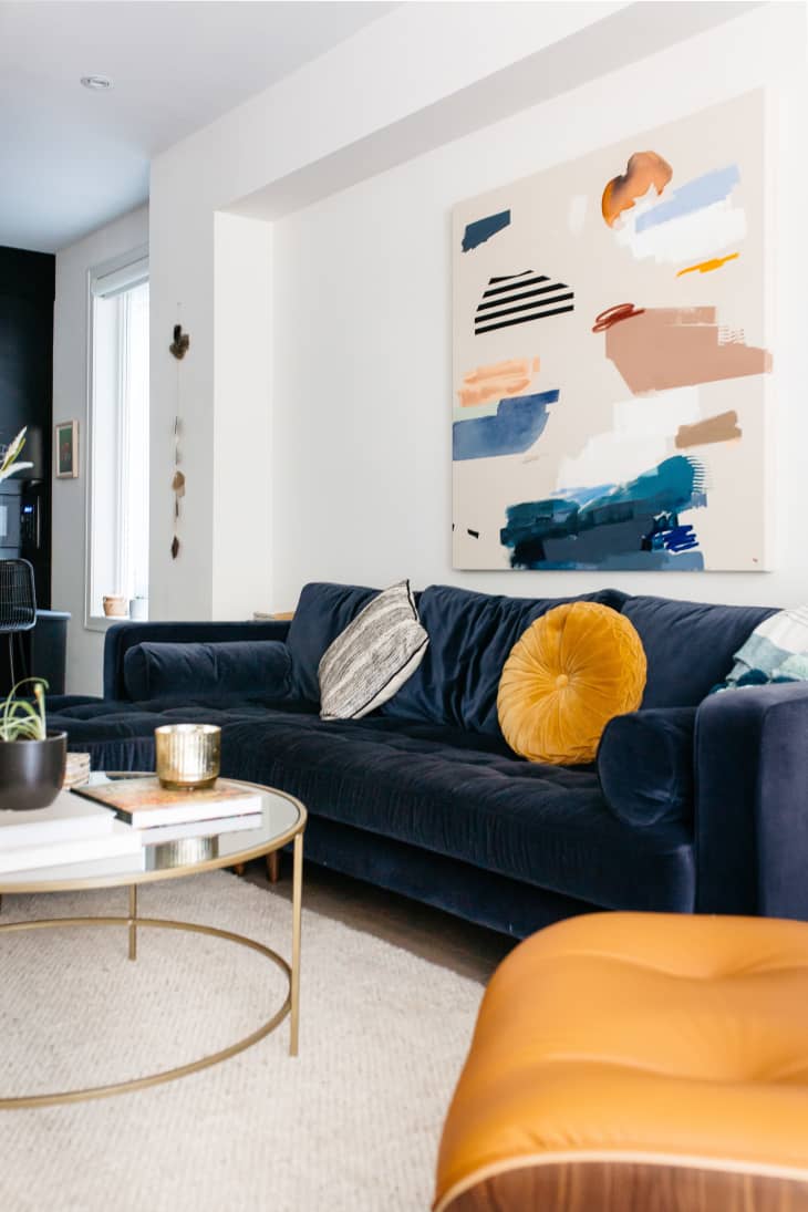 Living room with blue velvet sofa