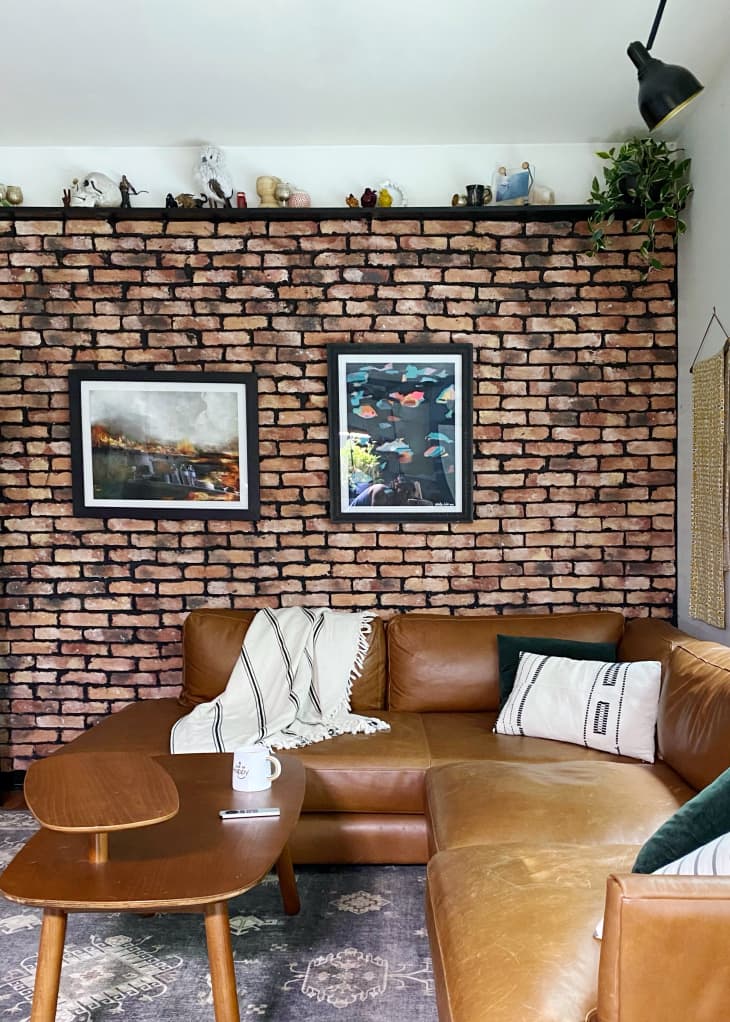 Living room with leather sectional and brick wall