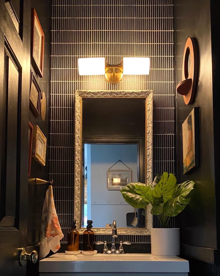 Moody bathroom with skinny black tiles
