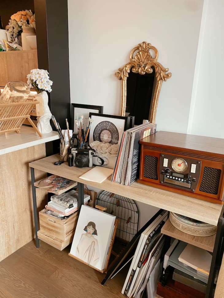 Vintage radio and camera on shelf with other decorative accents