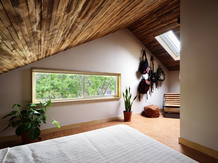 Bedroom with angled reclaimed wood ceiling