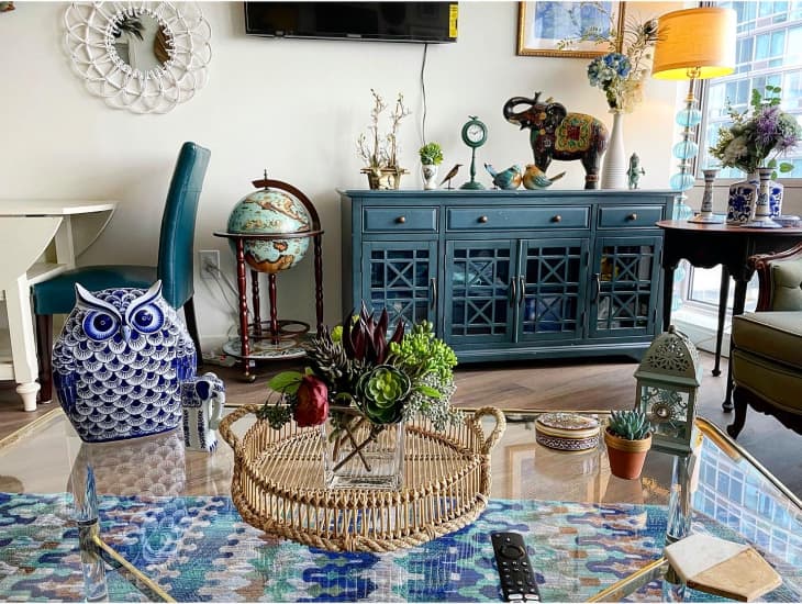 Boho living room with globe and teal console