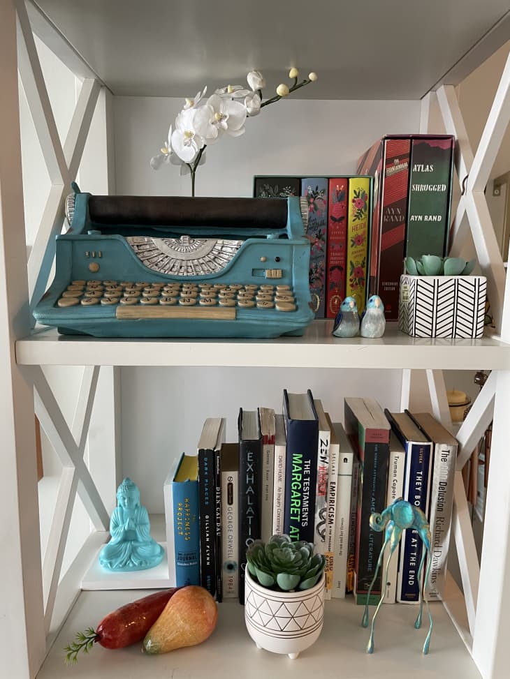 Bookshelf with typewriter and books on it