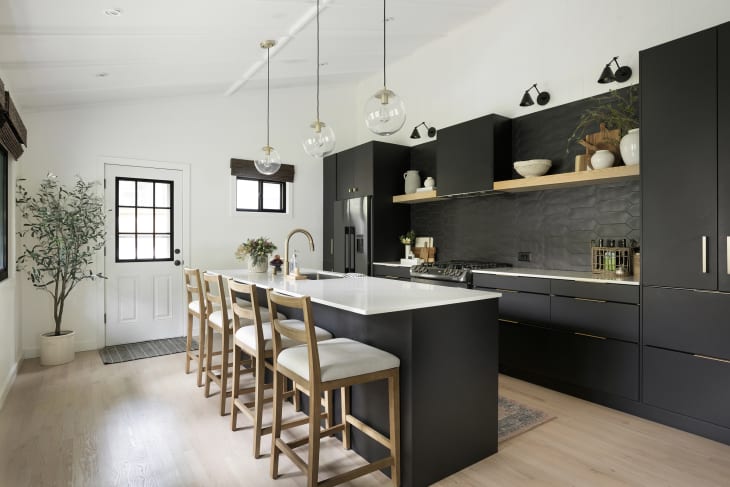Kitchen with black cabinetry and black backsplash