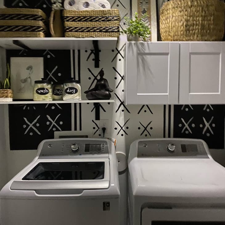 Organized laundry room with black and white color scheme
