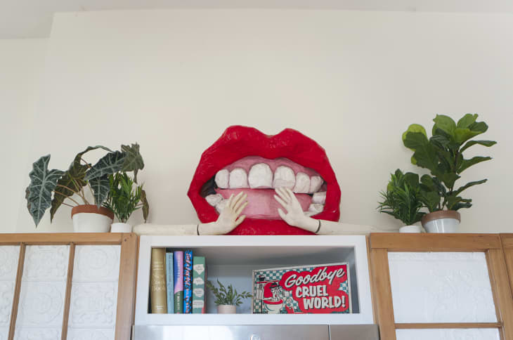 Mouth sculpture above cabinets