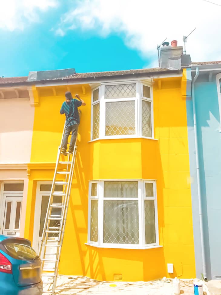 Row house in the UK painted a bright yellow paint color