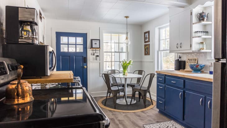 kitchen with blue cabinets and dining table