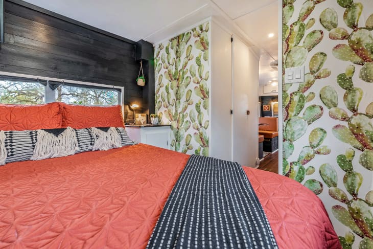 Cactus wallpaper in bedroom and orange bed
