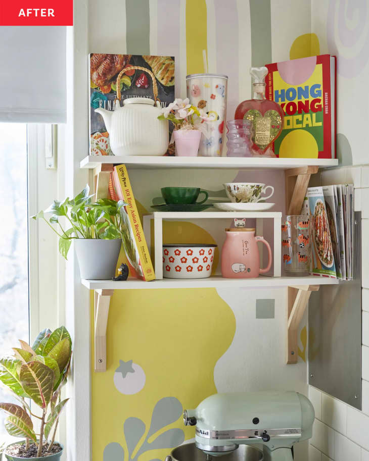 striped mural behind floating shelves above kitchen aid stand mixer on counter