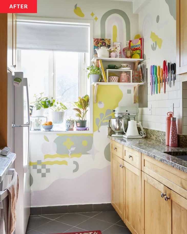 rainbow and geometric pastel mural on window wall with floating shelves in galley kitchen