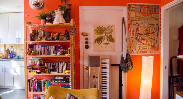 Orange room with book shelf and keyboard