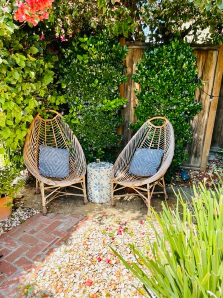 Two wicker chairs sitting outside