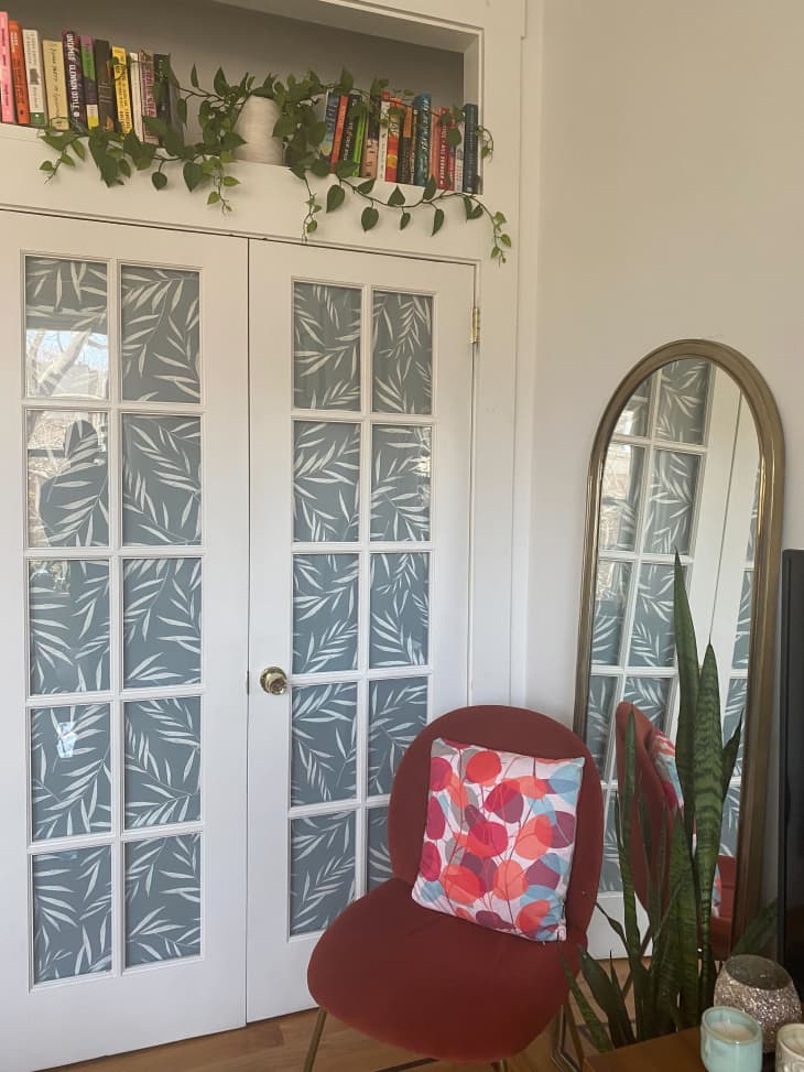 Red chair sitting next to double doors