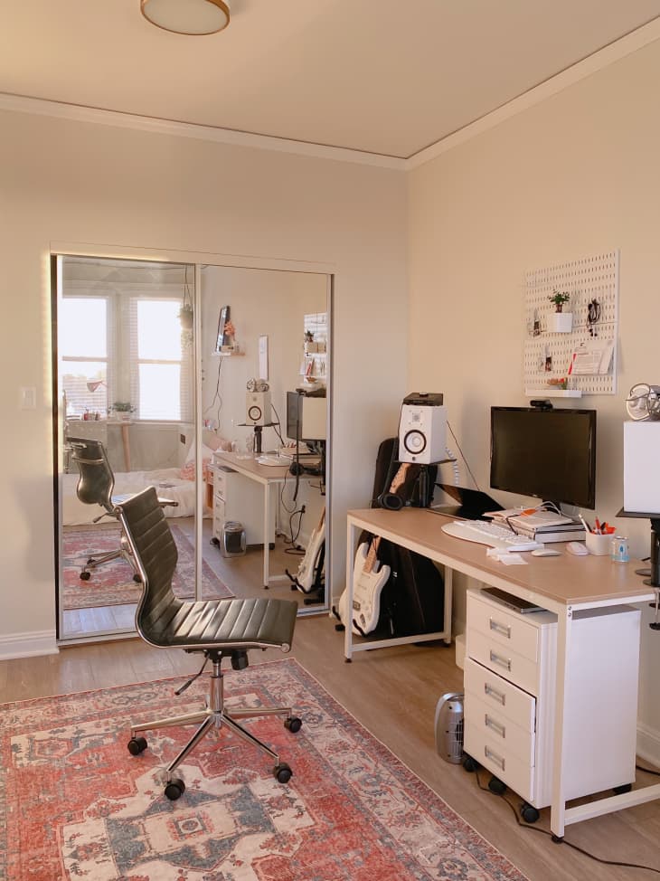 Office space with desk and chair on a red rug