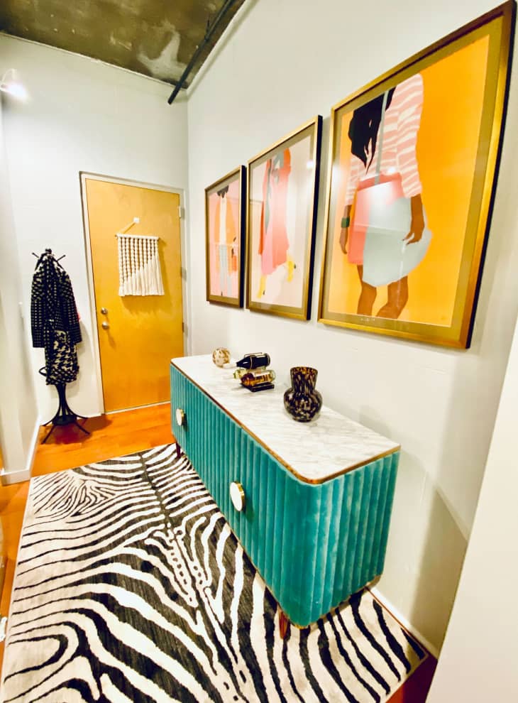 Entryway with zebra rug and yellow art