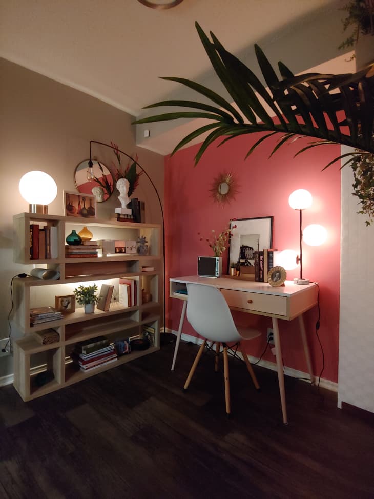 Office space in the corner of a room with pink and white walls