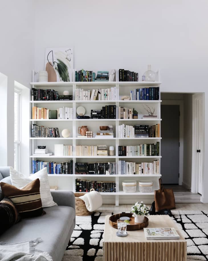 An oversized bookcase filled with books in a living room.