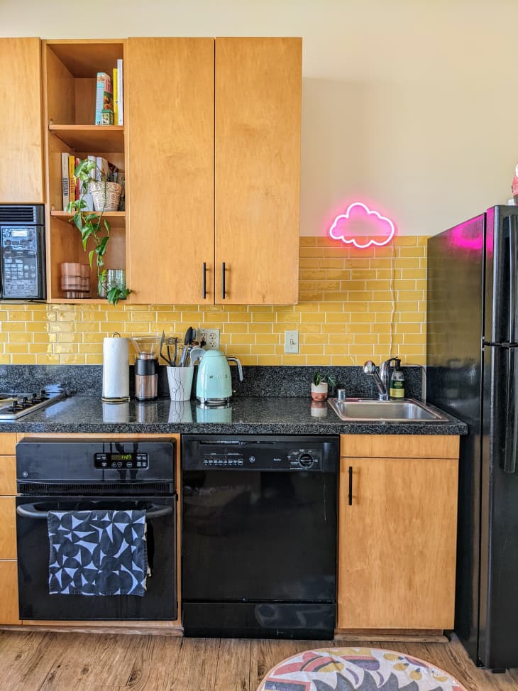 Kitchen with wooden cabinets and neon light above the sink