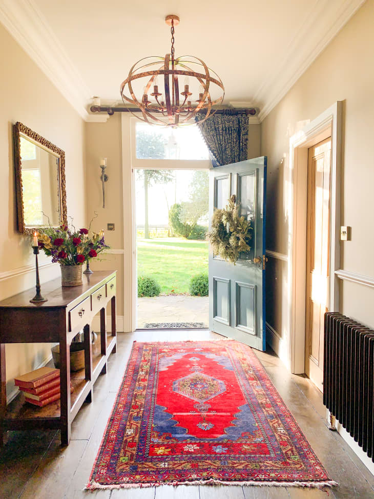 Entryway with long red runner rug