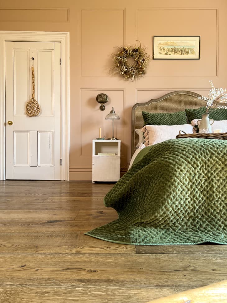 Bedroom with tan walls and green duvet