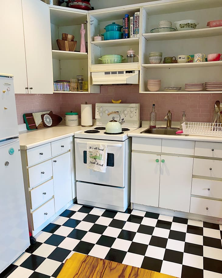 Kitchen with checkered floors and white cabinets