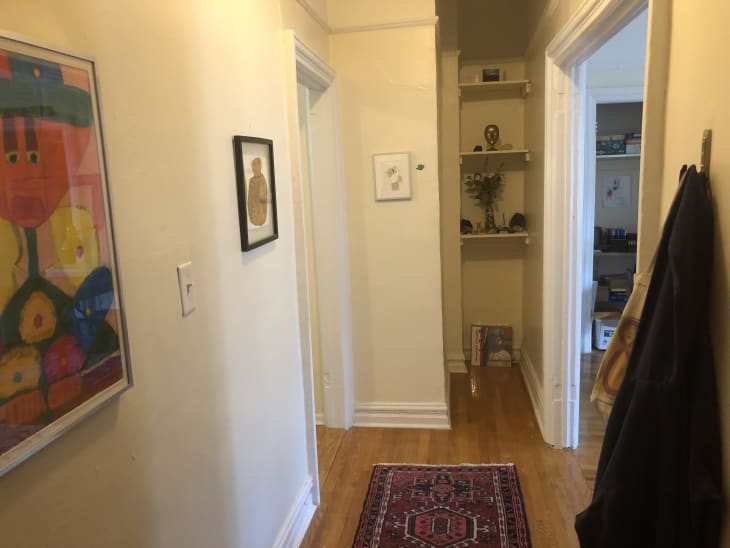 Hallway with red rug and art