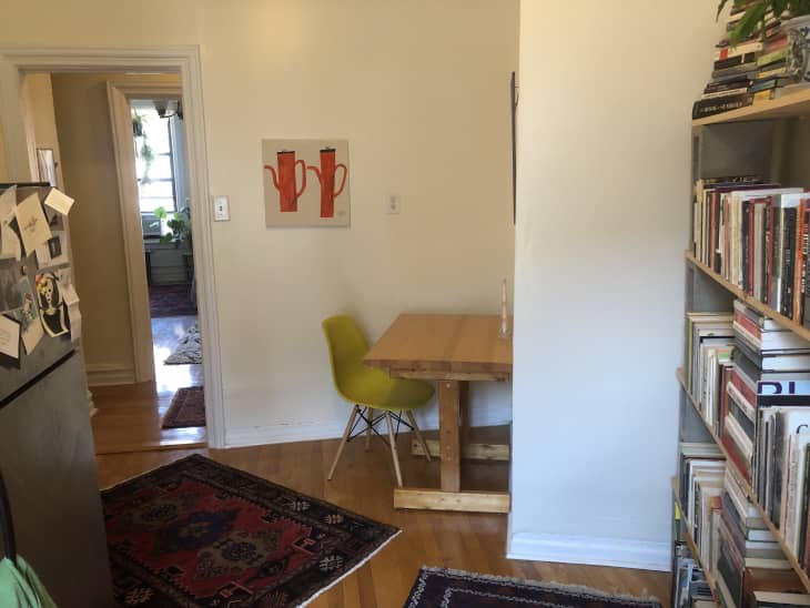 Small dining area in kitchen next to a bookshelf