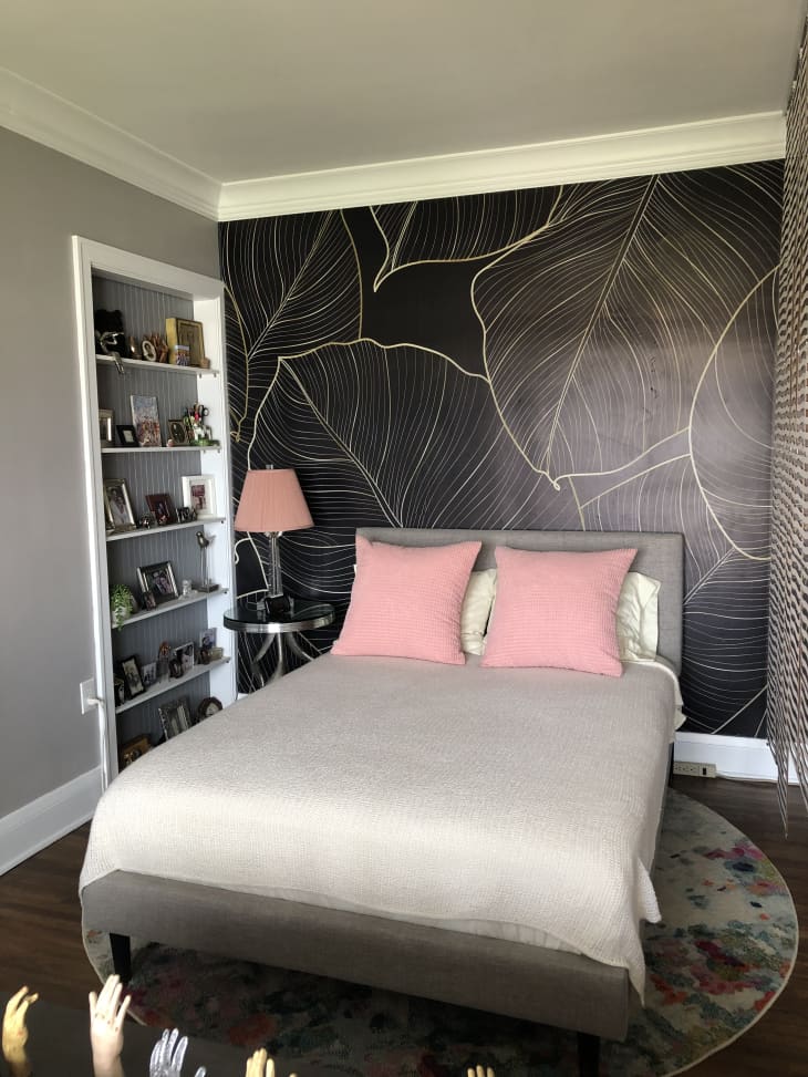 Bedroom with gray and pink bed in the middle