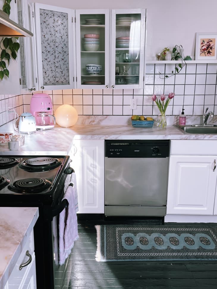 Kitchen with white cabinets and plants on the counter
