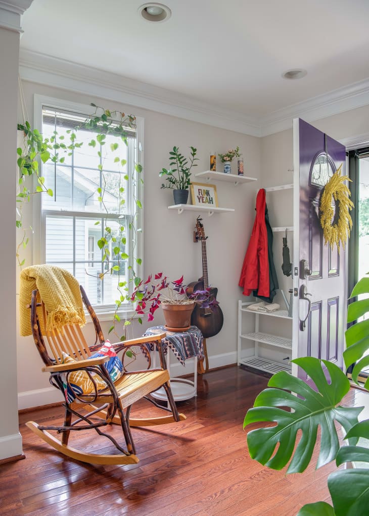 Rocking chair next to a window and a door