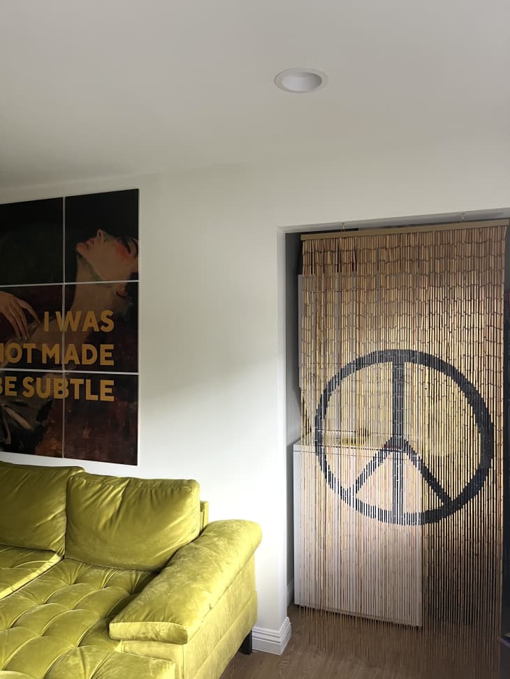Green and yellow couch next to a large peace sign