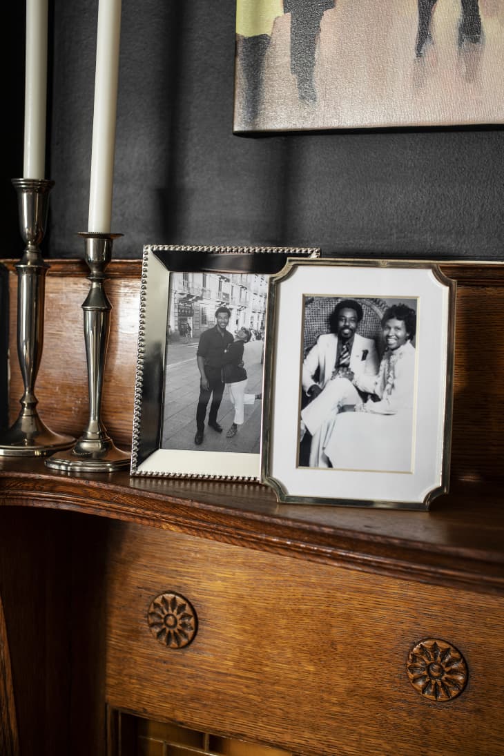 Two black and white framed photos on a wooden desk