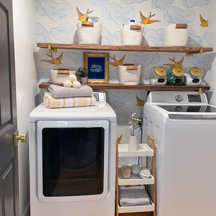 Laundry room with blue wallpaper and two wooden shelves