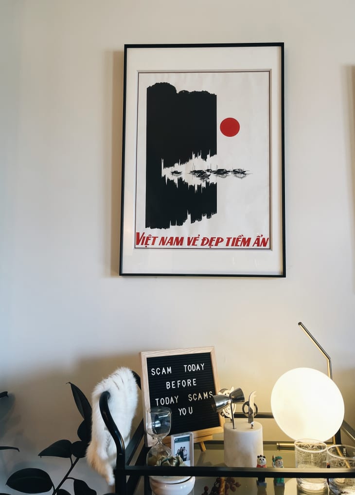 A framed poster above an end table