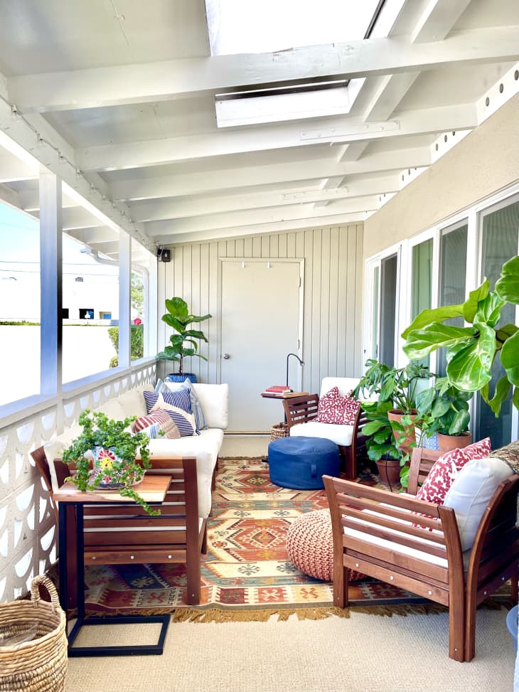 Enclosed porch with plants and chairs