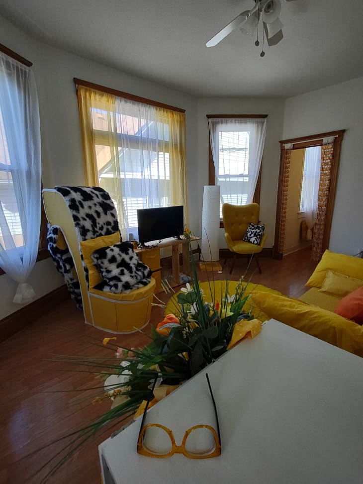 A living room with yellow furniture