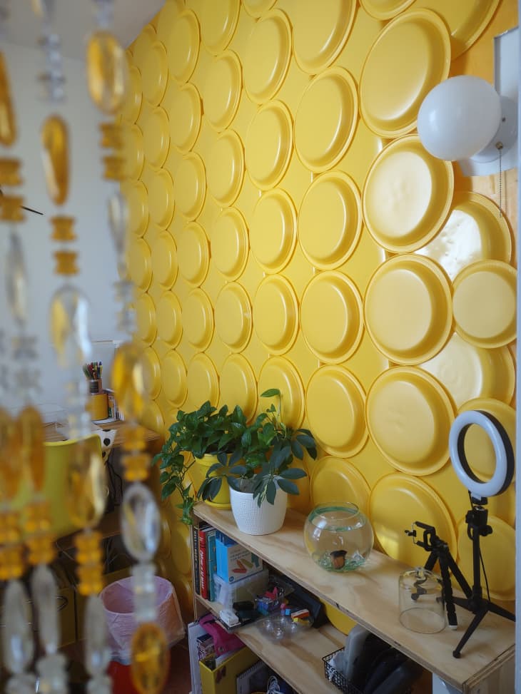 A yellow wall with yellow plates on it