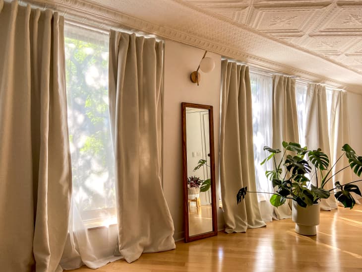 A wall with thick, flowing tan curtains