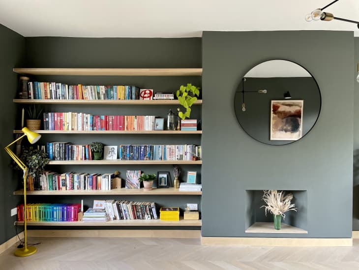 A built-in bookshelf that extends the length of the wall