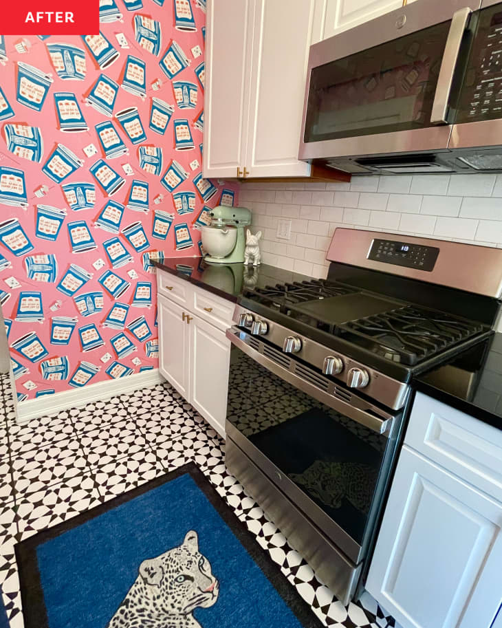 Pink and blue wallpaper with NYC Greek coffee cup motif in newly renovated kitchen with white cabinets and black countertop surfaces.