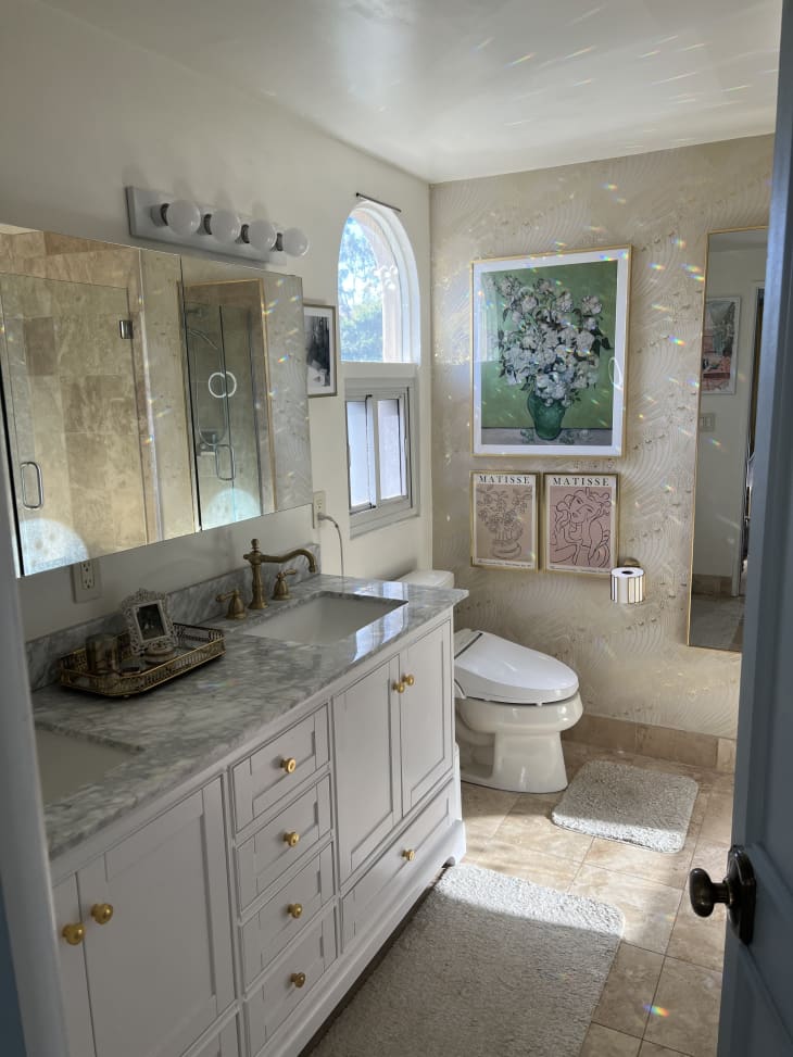 A bathroom with a double sink and marble counter tops