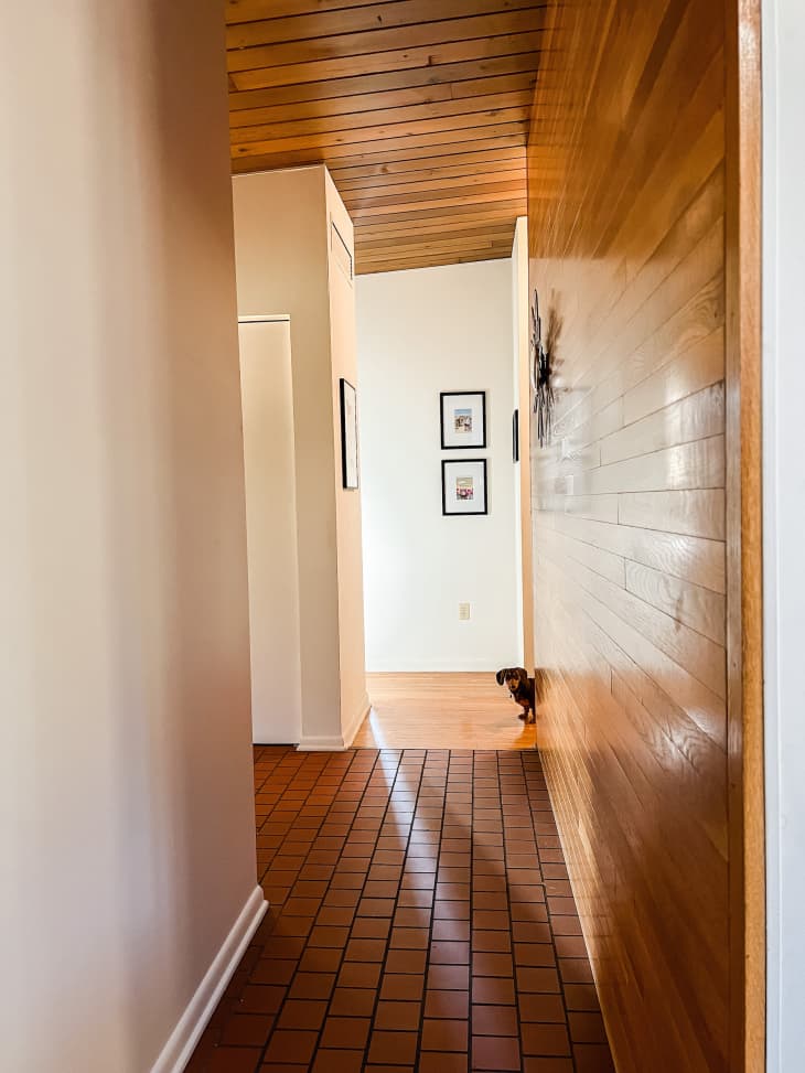 A hallway with wooden ceilings, floors, and walls