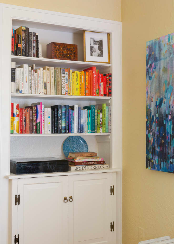 Built in bookshelf with color coded books.