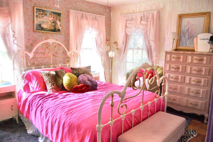 Colorful bedroom with lots of pink and lavender accents. One wall with opalescent beads. Lots of colorful art, decor