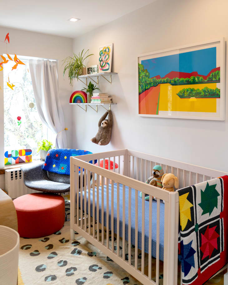 Colorful art filled baby nursery.