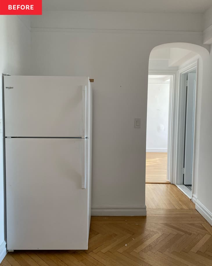 White kitchen with refrigerator before renovation.