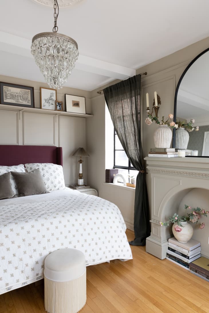 Floral patterned bedding on upholstered bedframe in neutral bedroom