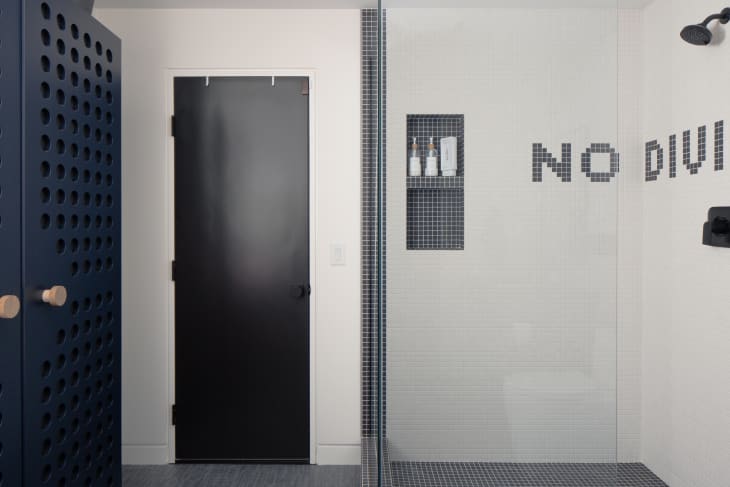 white tiled shower with words "no diving"