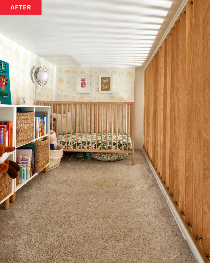 White lofted nursery with wood railings, beige carpet, and animal print wallpaper